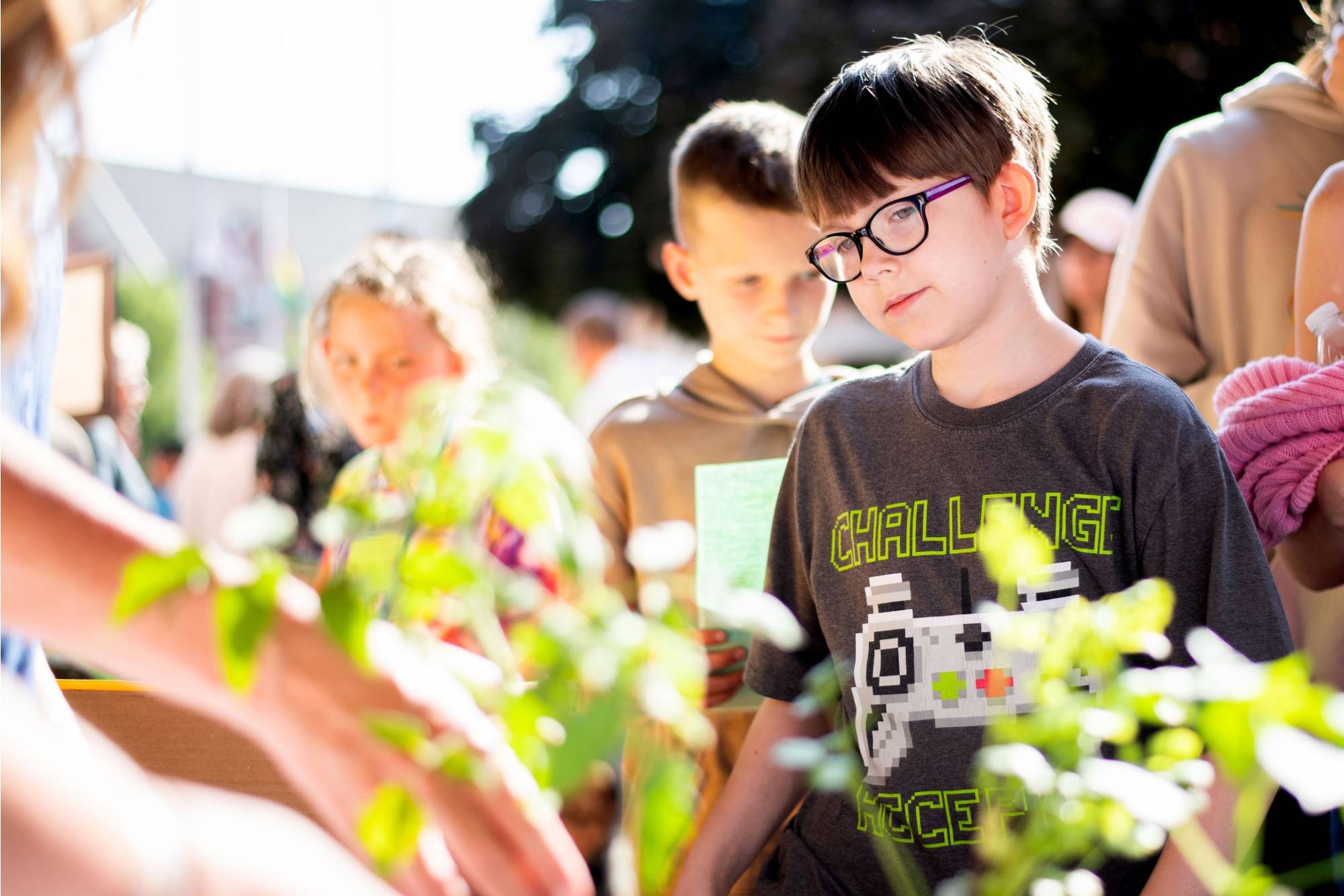 Student looks at plant